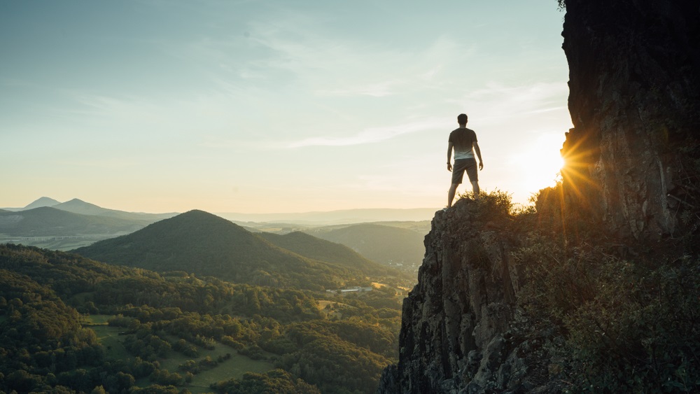 Man Standing on the Edge of a Cliff