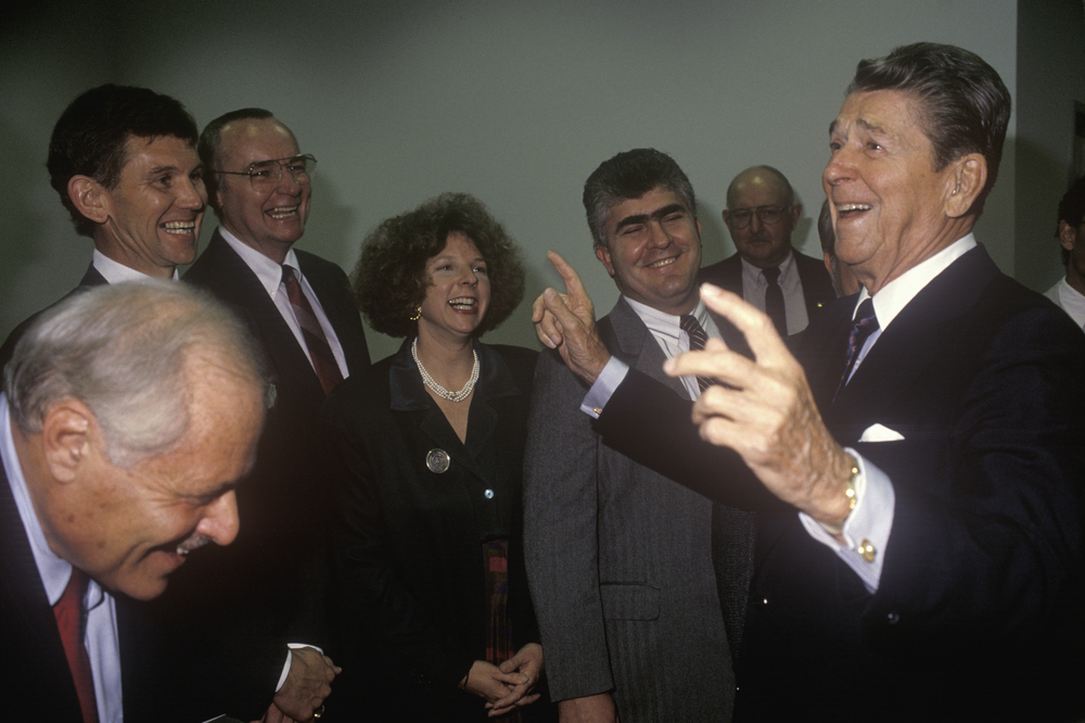 President Ronald Reagan jokes with politicians and reporters and tells a joke