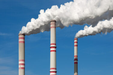 Chimney smoke with blue sky