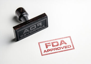 Rubber stamping that says 'FDA Approved'.
