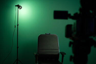 Green screen background and a black chair in a television Studio