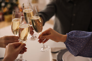 People clinking glasses with champagne at home