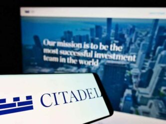 Cellphone with business logo of US financial services company Citadel LLC on screen in front of website.