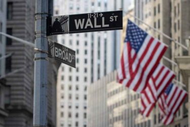 The Wall Street sign is seen outside the New York Stock Exchange (NYSE) Building in the Financial District of Lower Manhattan in New York City.