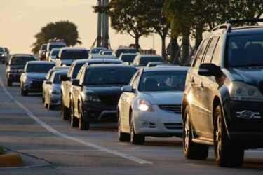 Cars Lined Up in Bumper-to-Bumper Rush-Hour Traffic Heading East on Sample Road Next to Turnpike in Pompano Beach, Florida at Sunset