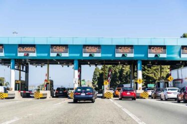 Cars stopping at Carquinez Bridge Toll Plaza to pay for the use of the bridge of eastbound traffic; north San Francisco bay area.