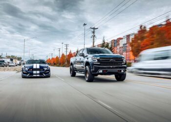 Ford Shelby GT 350 and Chevy Z71 driving side by side on the road