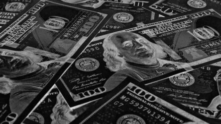 American paper money. 100 dollar and other US notes. Black and white wallpaper or background.