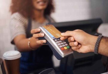 Credit card machine, cafe and hands of customer for b2c shopping, point of sale transaction and finance.