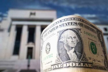 dollars on the background Federal Reserve Building in Washington DC, United States