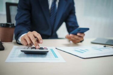 Businessman using calculator