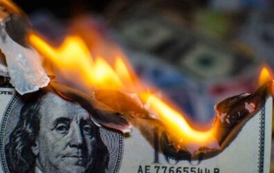A hundred dollar bill in American US currency is on fire