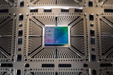 Close-up of Colorful Silicon Die Attached to Substrate on Semiconductor Factory.