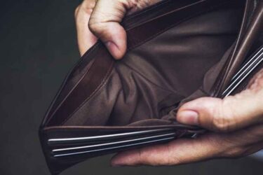 Man holding open an empty wallet