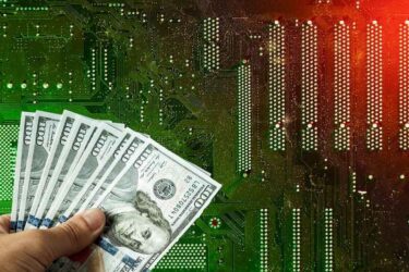 American dollars in hand on the background of a printed circuit board, electronic semiconductor microcircuit.