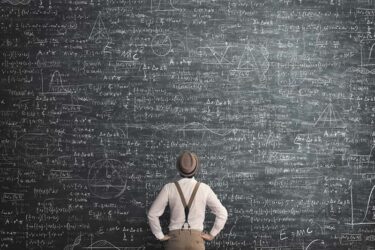 Man looking at formulas on a chalkboard