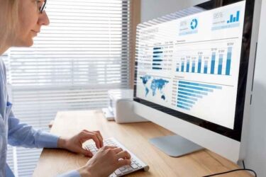 Manager analysing performance data on dashboard