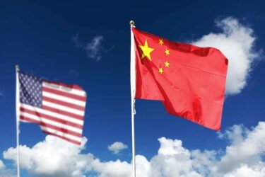 China and U.S. Flag with a clear sky.