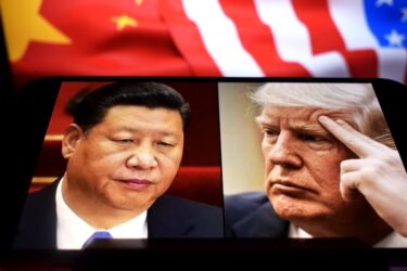U.S. President Donald Trump and President of the People's Republic of China Xi Jinping appear on a smartphone screen.